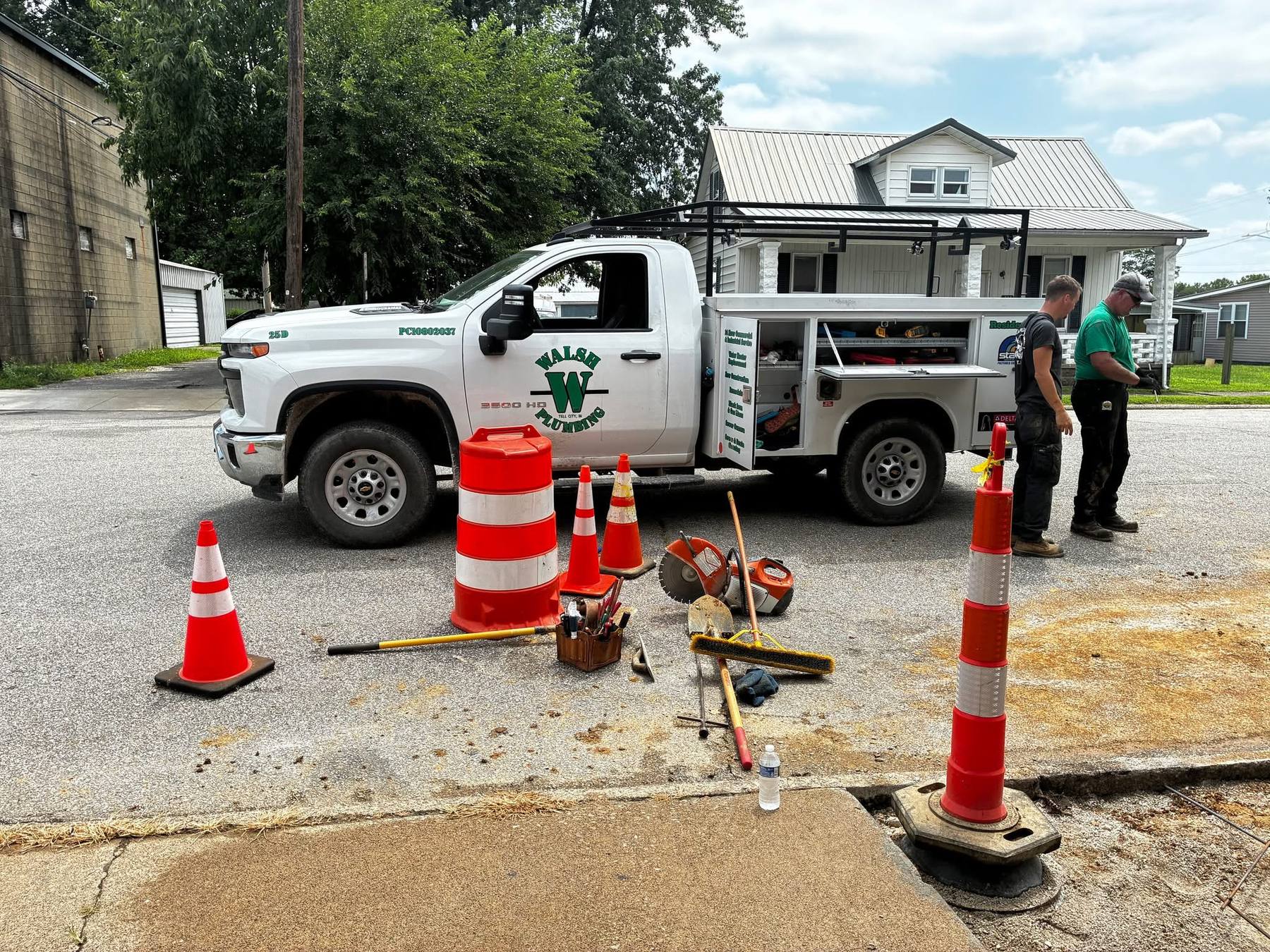 Walsh Plumbing service truck and crew set up on a job site in Tell City, Indiana